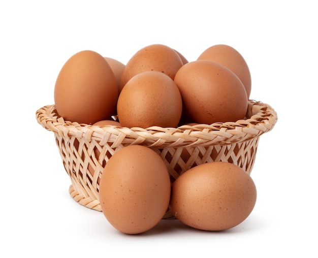 Eggs in basket isolated on white background