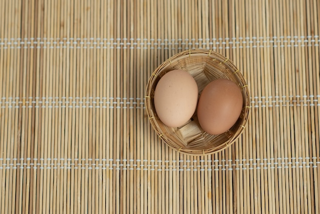 Eggs in a basket on wooden table