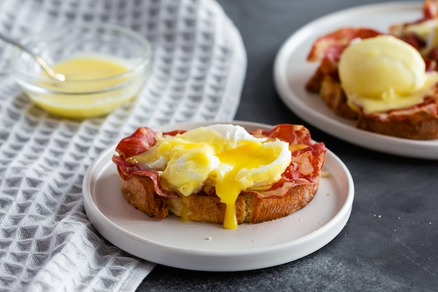 Eggs Benedict- toasted English bread, parm ham, poached eggs with hollandaise sauce and lemon on gray