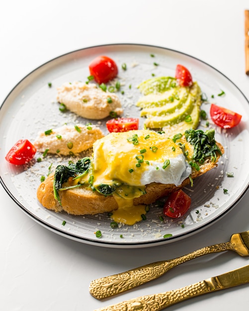 Eggs benedict with chicken pate and avocado