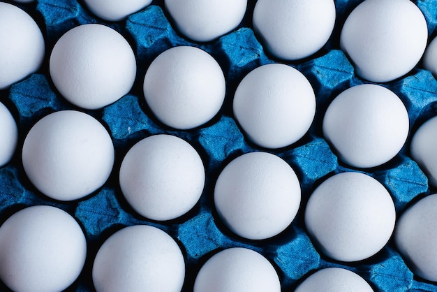 Eggs in blue coloring tray in closeup photo and top view