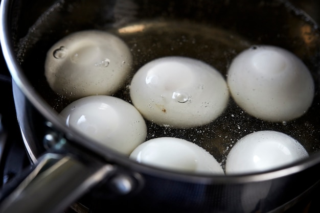 eggs boiling in pan of water