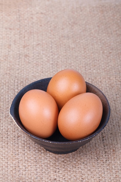 Eggs in a bowl on brown sack