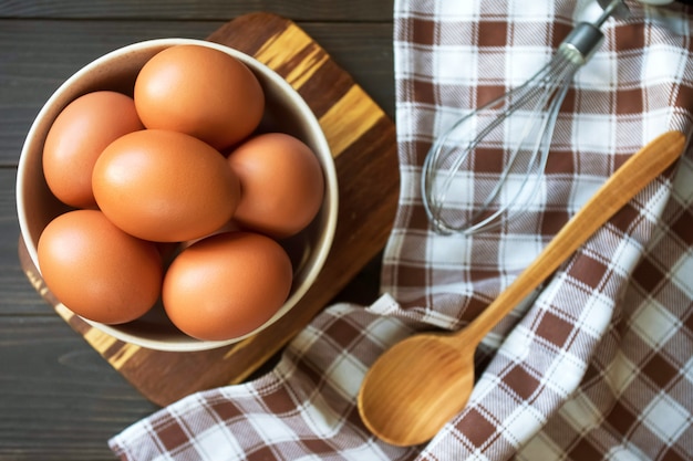 Eggs in a bowl and wooden spoon