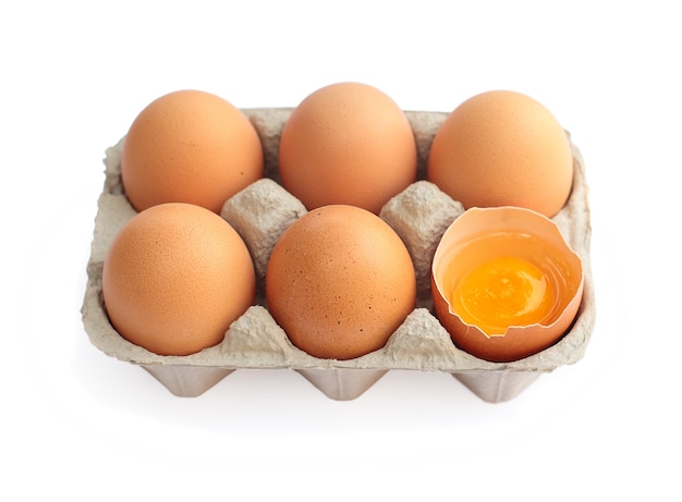 Eggs in cardboard container isolated on white background