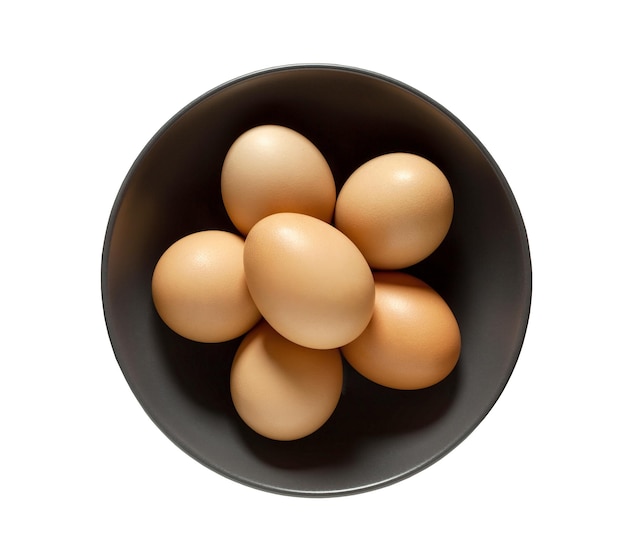 Eggs chicken whole beige in bowl isolated on white background with clipping path