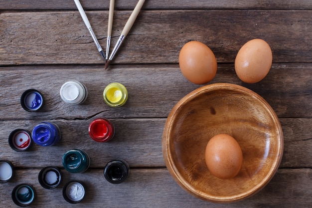 Eggs and color on wooden background