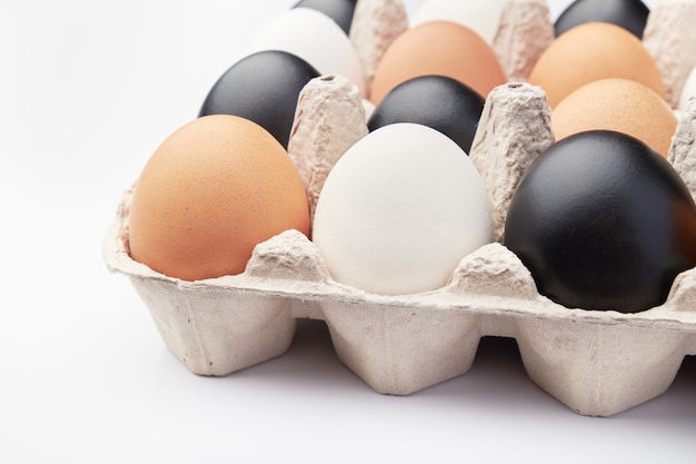 Eggs of different colors in cardboard boxes