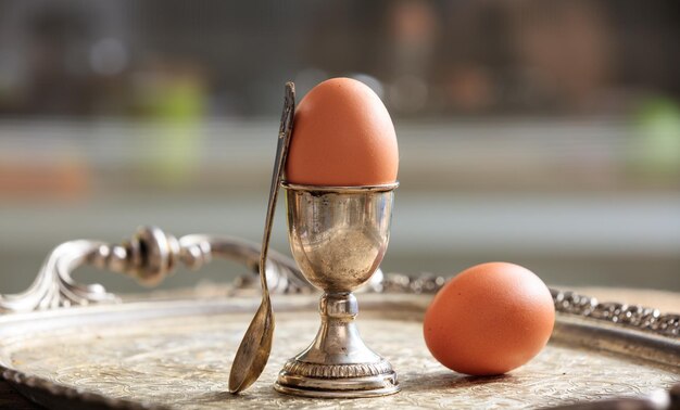 Eggs and egg cup in an old tray