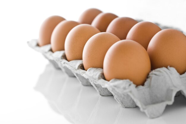 Eggs in the eggs carton isolated on white