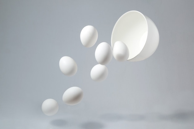 Eggs falling out of a bowl isolated