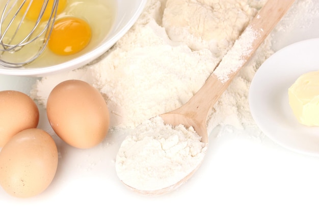 Eggs flour and butter closeup isolated on white