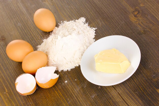 Eggs flour and butter closeup on wooden table