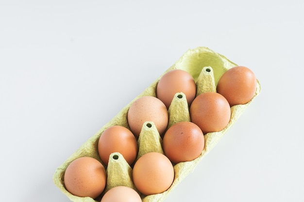 Eggs from egg tray isolated on white background Eggs protected in a light paper recycling tray