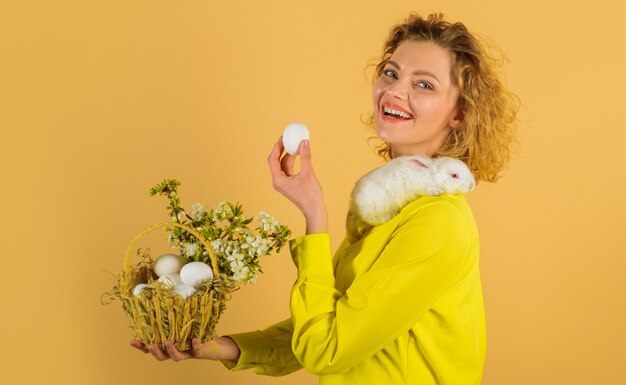 Eggs hunt, Easter egg, Smiling woman with basket eggs, Spring holidays.