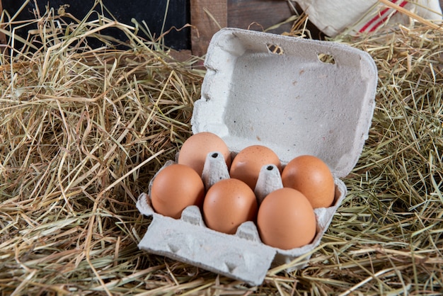 Eggs in the package on the straw