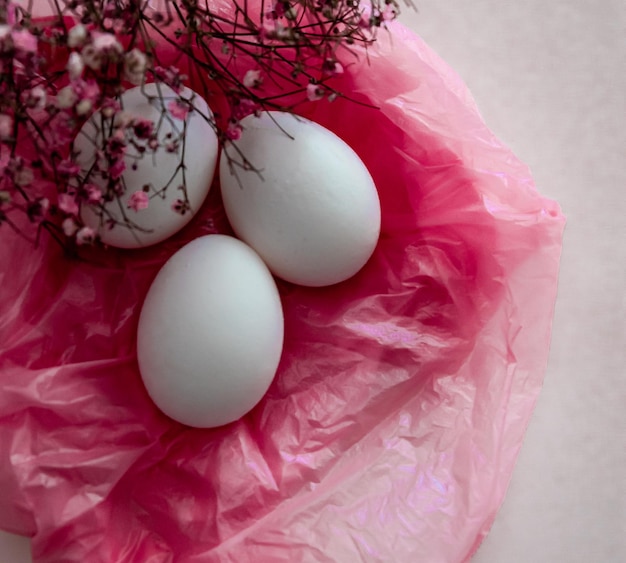 eggs on a pink background in a basket High quality photo pink ink bright pink background three