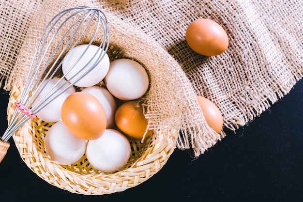 Eggs on tablecloth over black 