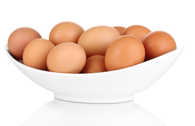 Eggs in white bowl isolated on white