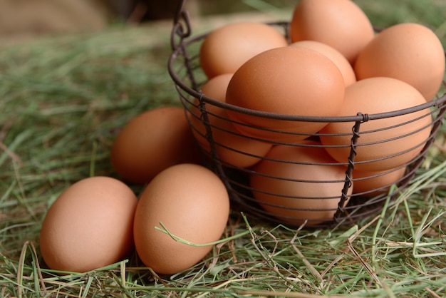 Eggs in wicker basket on table closeup