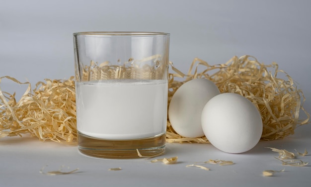 eggs with milk on a background of hay