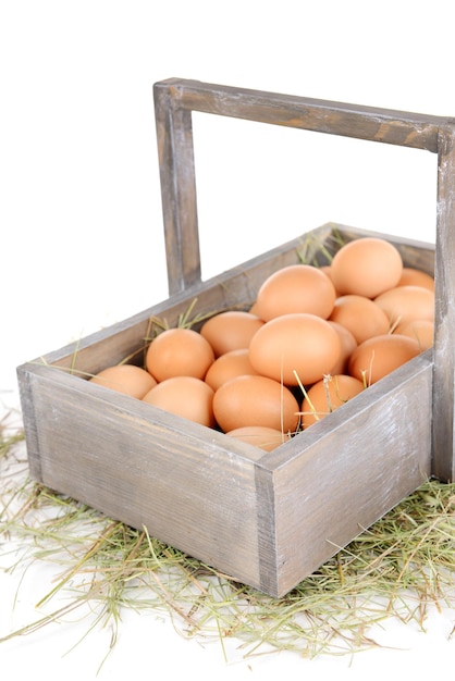 Eggs in wooden basket isolated on white