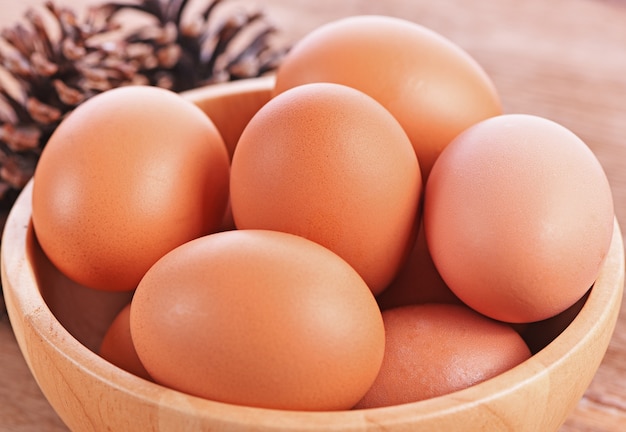 Eggs in Wooden bowl on wooden background