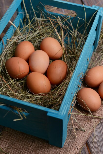 Eggs in wooden box on table closeup