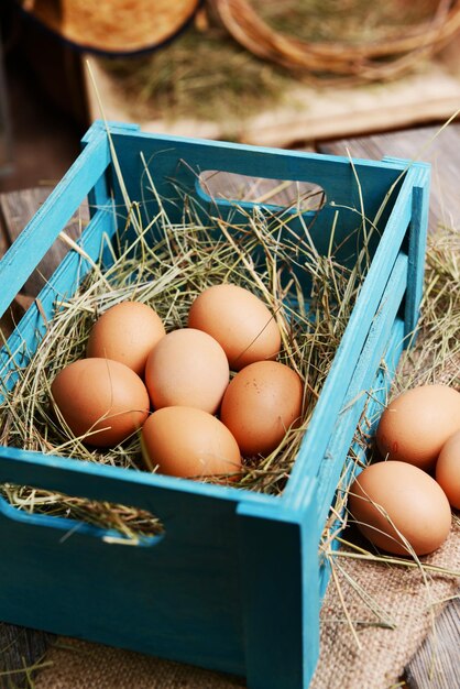 Eggs in wooden box on table closeup