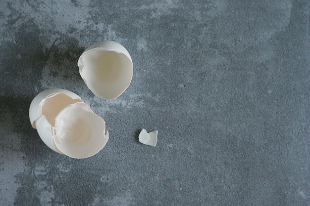 An eggshell lies on a gray concrete table Copy space Zero waste concept