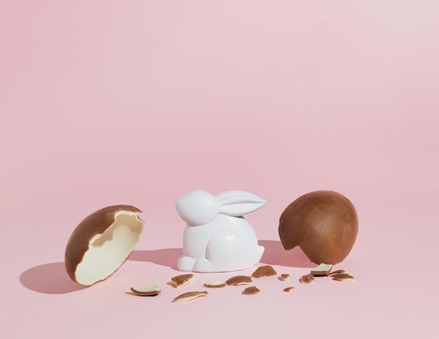 Eggshell with bunny rabbit Creative copy space on pink background Minimal Easter holiday concept