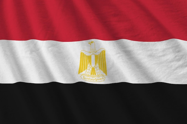 Egypt flag with big folds waving close up under the studio light indoors The official symbols and colors in banner