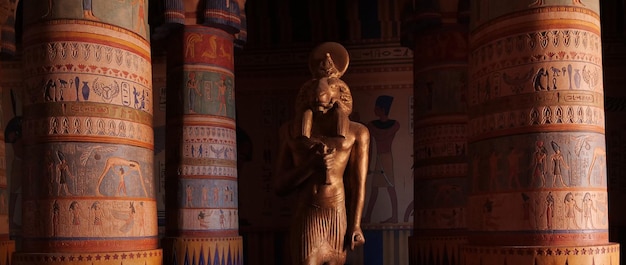 Egyptian room with columns and carvings and statue of a god