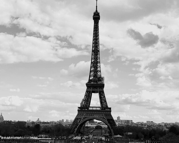 Eiffel tower against cloudy sky