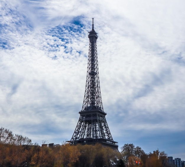 Eiffel Tower in Paris France against blue sky with clouds April 2019