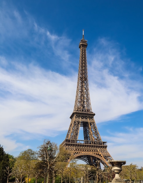 Eiffel tower in paris france against blue sky with clouds april