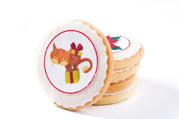 Eigengemaakte boterkoekjes met een gedrukt die ontwerp van de Kerstmiskat op wit wordt geïsoleerd