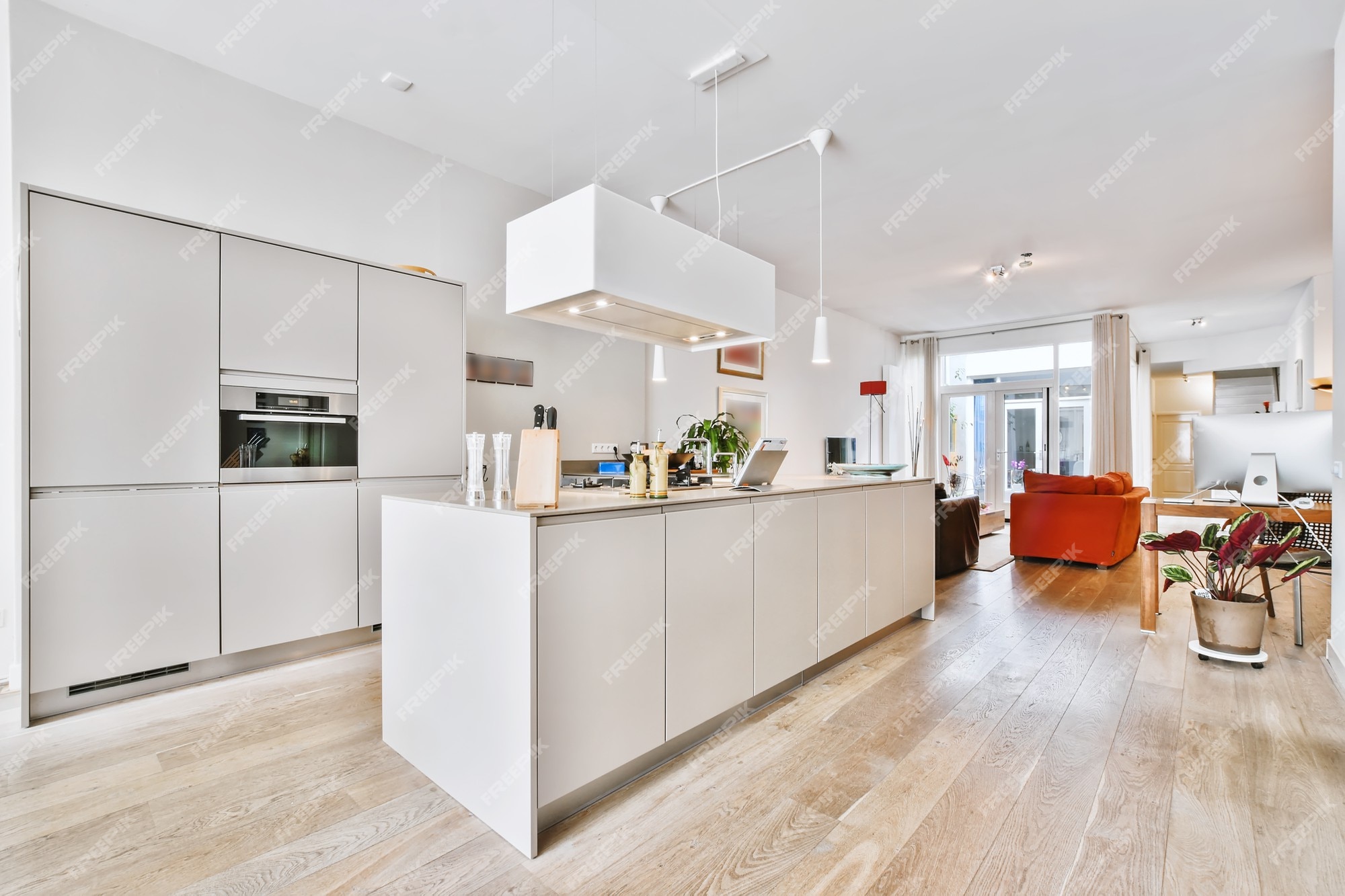 Schiereiland Onvervangbaar wenselijk Eigentijdse witte keukenkasten met inbouwapparatuur en hangende afzuigkap  in ruime woning | Premium Foto