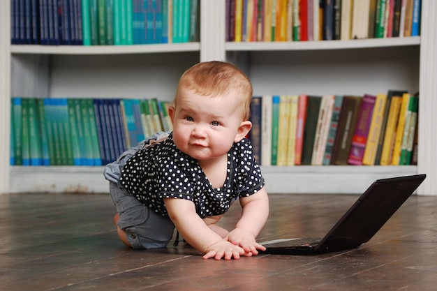 Eight months old toddler baby playing with tablet pc on the floor