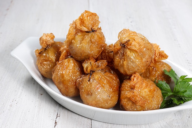 ekado or ekkado is processed fish or shrimp meat wrapped in dumpling skin and shaped like a bag