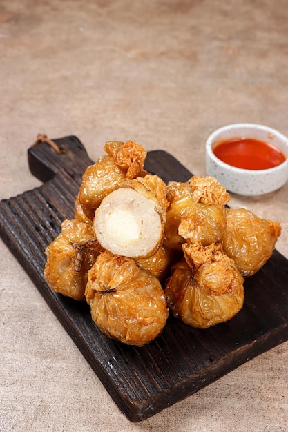 Ekado or ekkado is processed fish or shrimp meat wrapped in dumpling skin and shaped like a bag