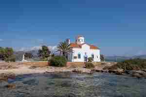 Photo elafonisos peloponnese greece agios spyridon church at island port sunny day blue sky