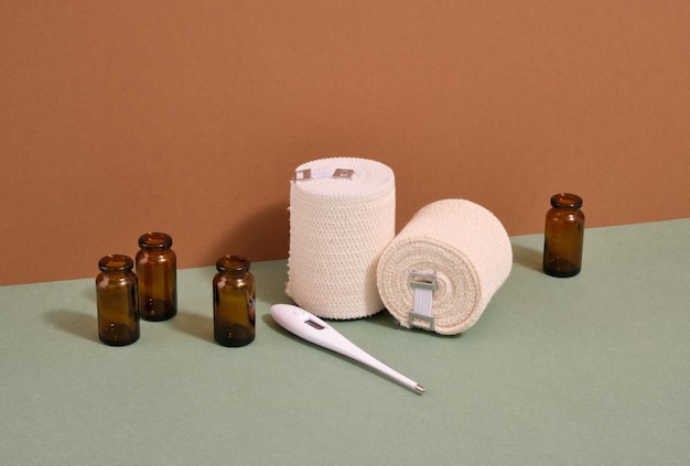 Elastic bandages thermometer and empty glass jars for medications