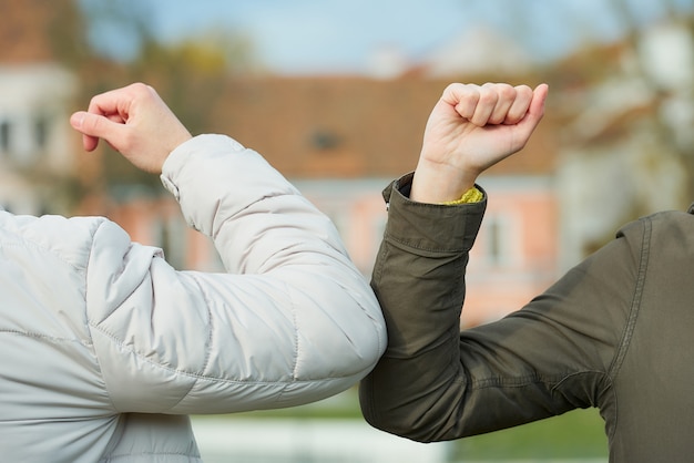 Photo elbow bumping. elbow greeting to avoid the spread of coronavirus (covid-19).