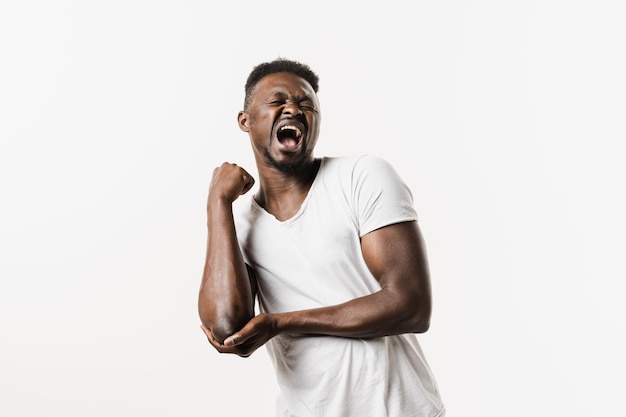 Elbow injury of african american man isolated on white background Elbow injury causing pain swelling stiffness and limited movement Fractures dislocations sprains and tennis elbow