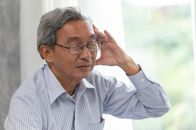 Elder headache illness symptom from wearing glasses.