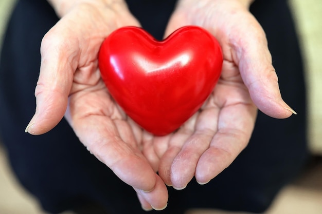 Elder woman holding heart