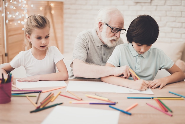 Elderly Artist Teaches Kids to Draw with Pencils. Back to School 