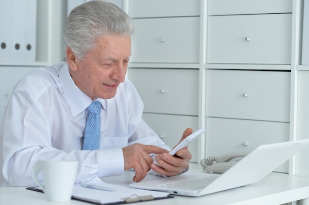 Elderly businessman working in the office