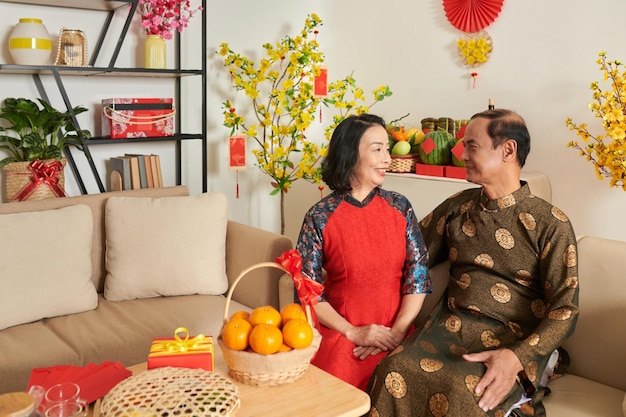 Premium Photo | Elderly couple celebrating tet at home